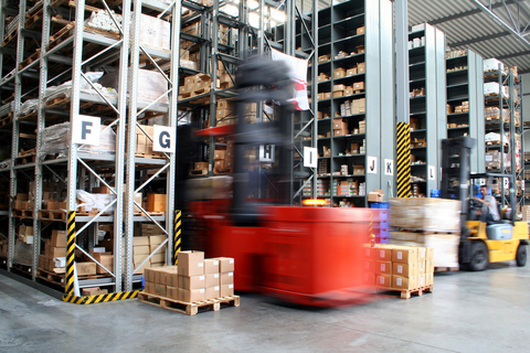VNA forklift in motion entering racking aisle